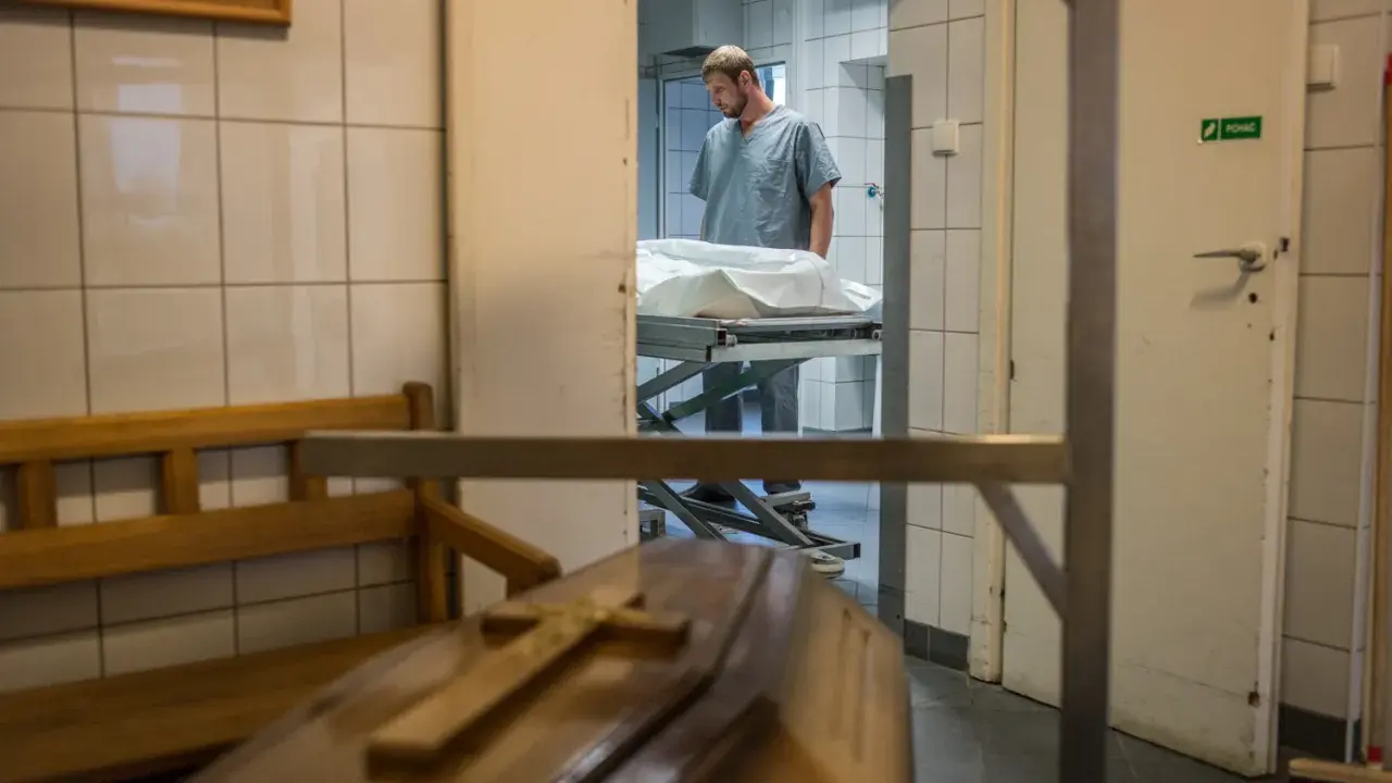 W prosektorium, po sekcji zwłok, pracownik pochyla się nad noszami. Czy po sekcji zwłok można otworzyć trumnę?